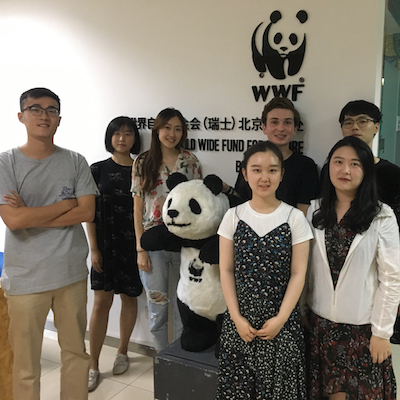 Will Lighthart and others standing in front of the WWF logo in Beijing China